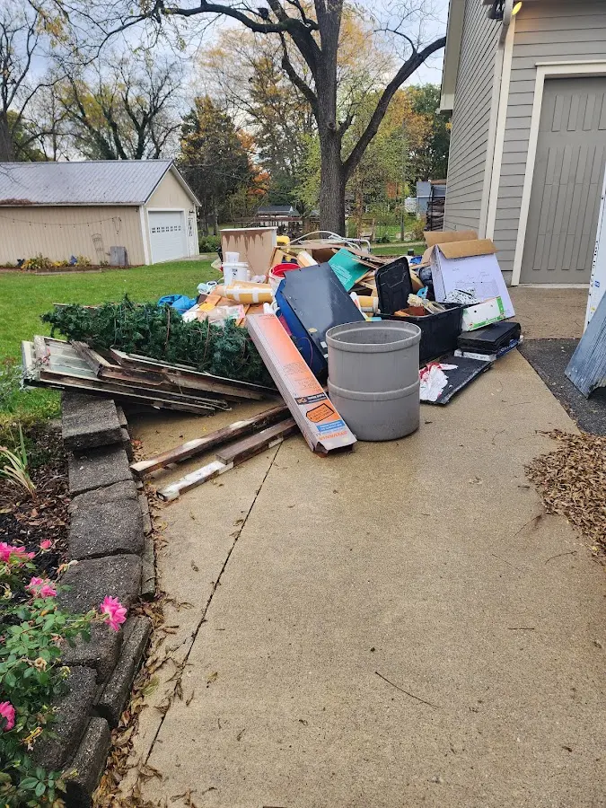 Dumpster being loaded with debris for Estate Cleanout Dumpster Rental in Eagle Lake
